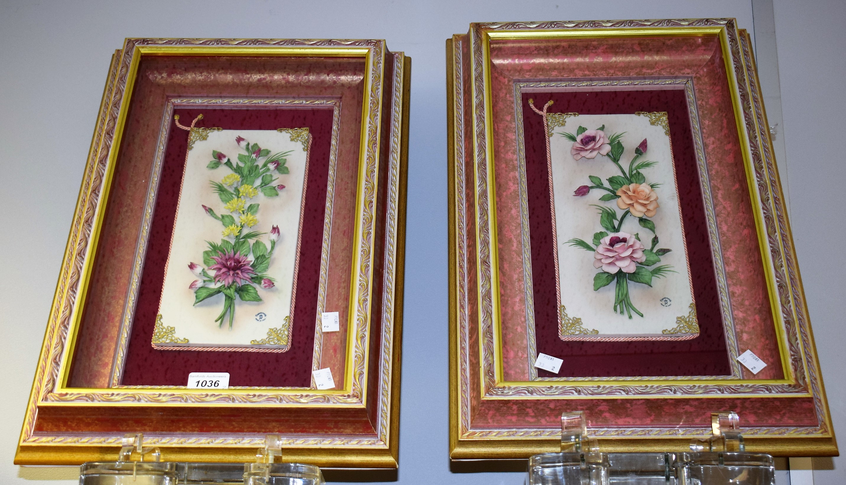 A pair of Capodimonte floral wall plaques,