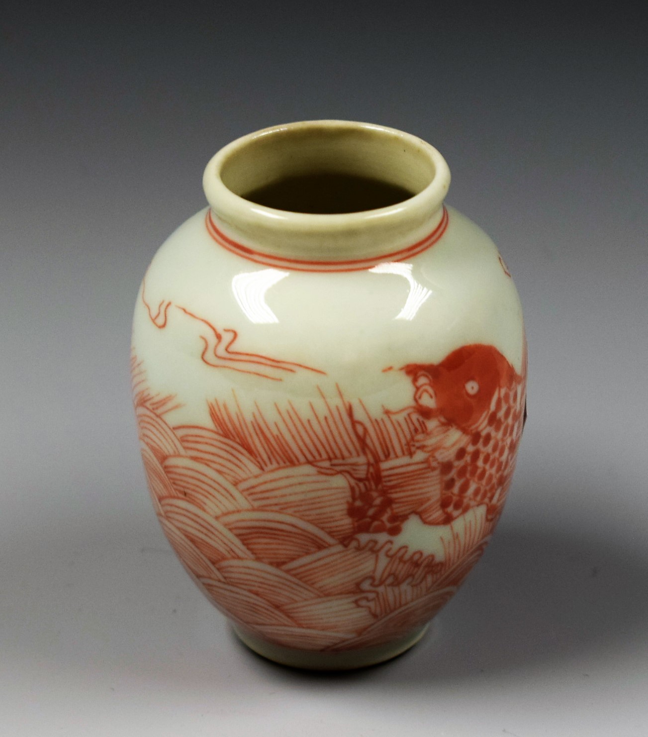 A Chinese miniature ovoid vase, painted in underglaze red with carp amongst rolling waves, 6.