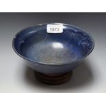 A Japanese monochrome stoneware flared circular bowl, glazed in mottled tones of purple, 18cm diam,