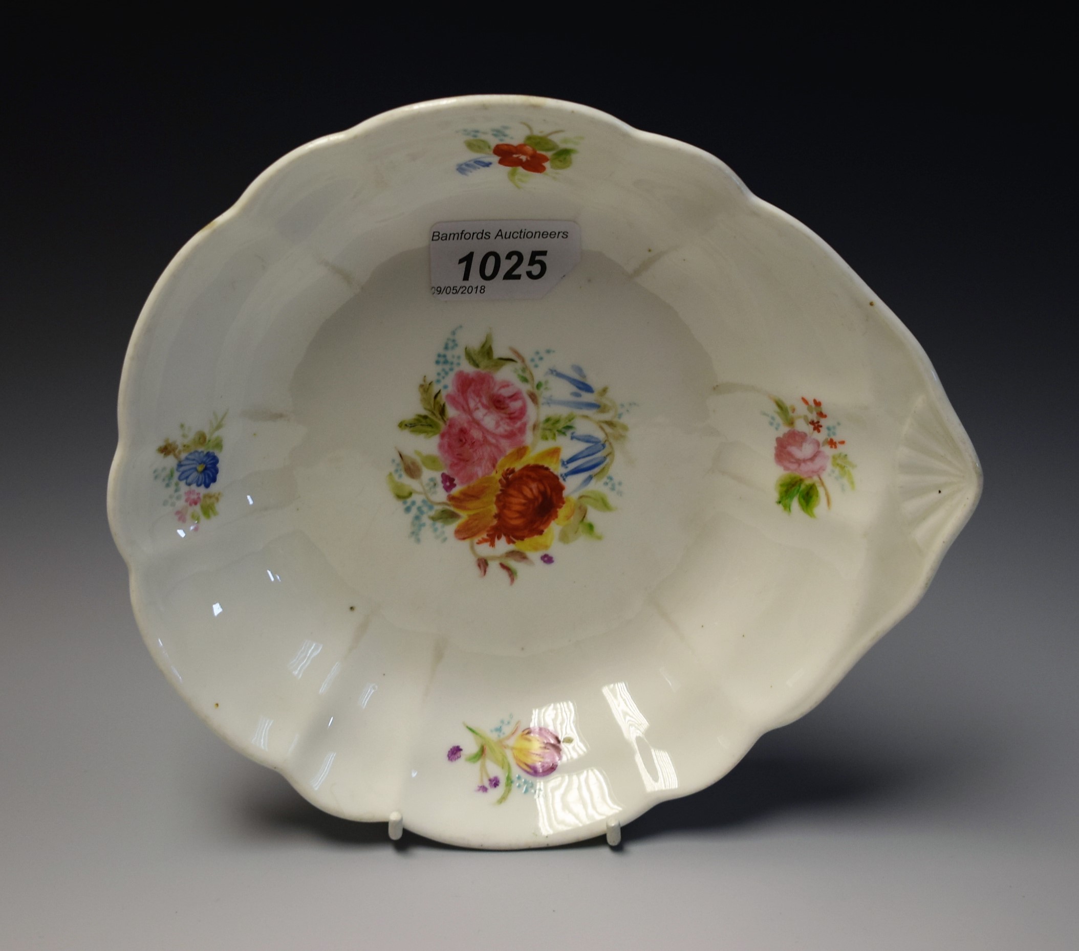 A Nantgarw shaped circular plate, the rim brightly painted with apple blossom,