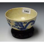 A Chinese bowl, painted on tones of blue with dragons chasing a flaming pearl,