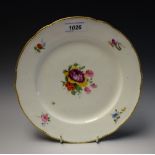 A Nantgarw shaped circular plate, painted with a bouquet of colourful summer flowers,