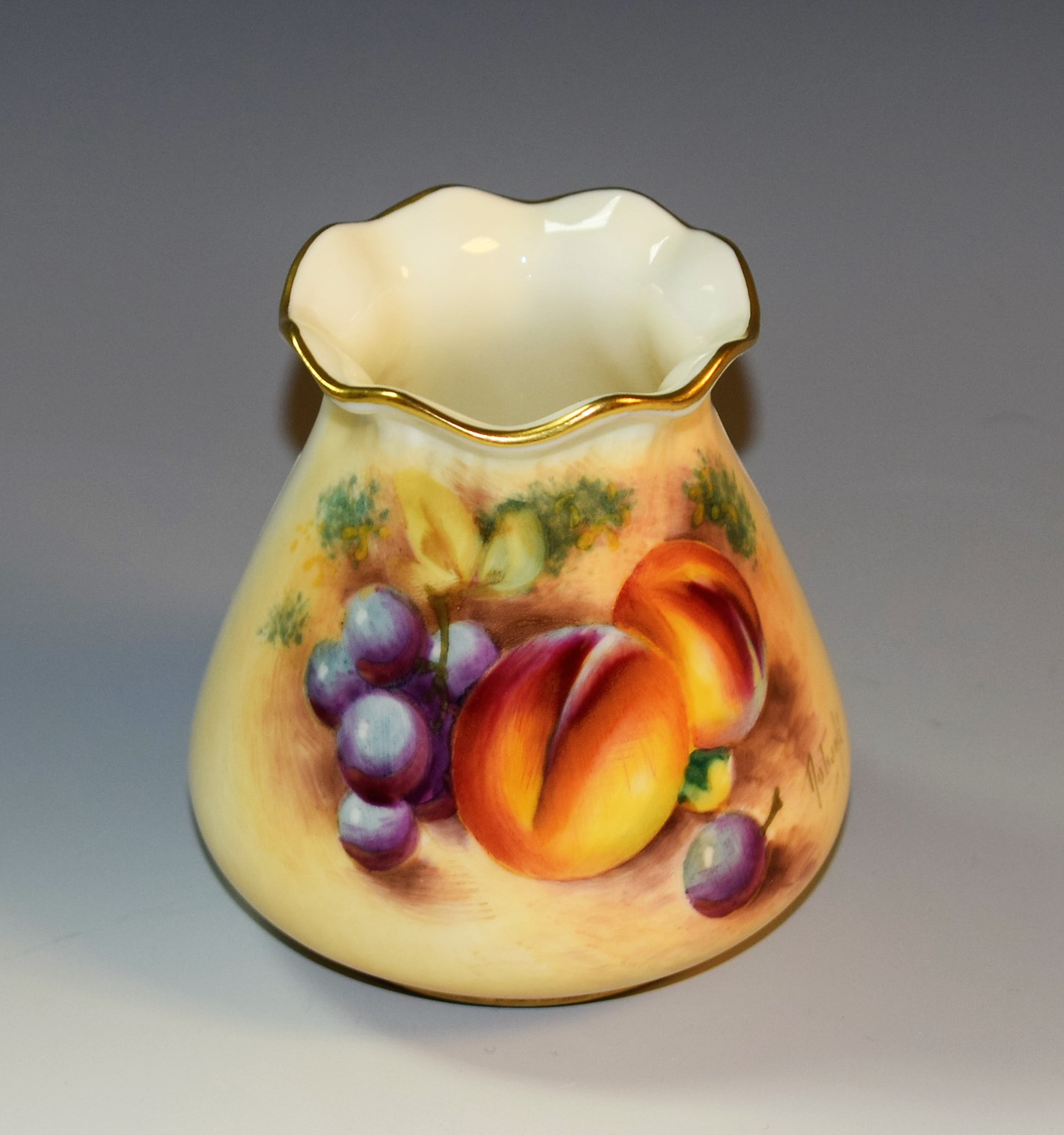 A Royal Worcester vase, painted by Roberts, signed, with peaches and grapes on a mossy ground,