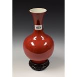 A Chinese monochrome ovoid vase, red glaze, flared rim, 24.