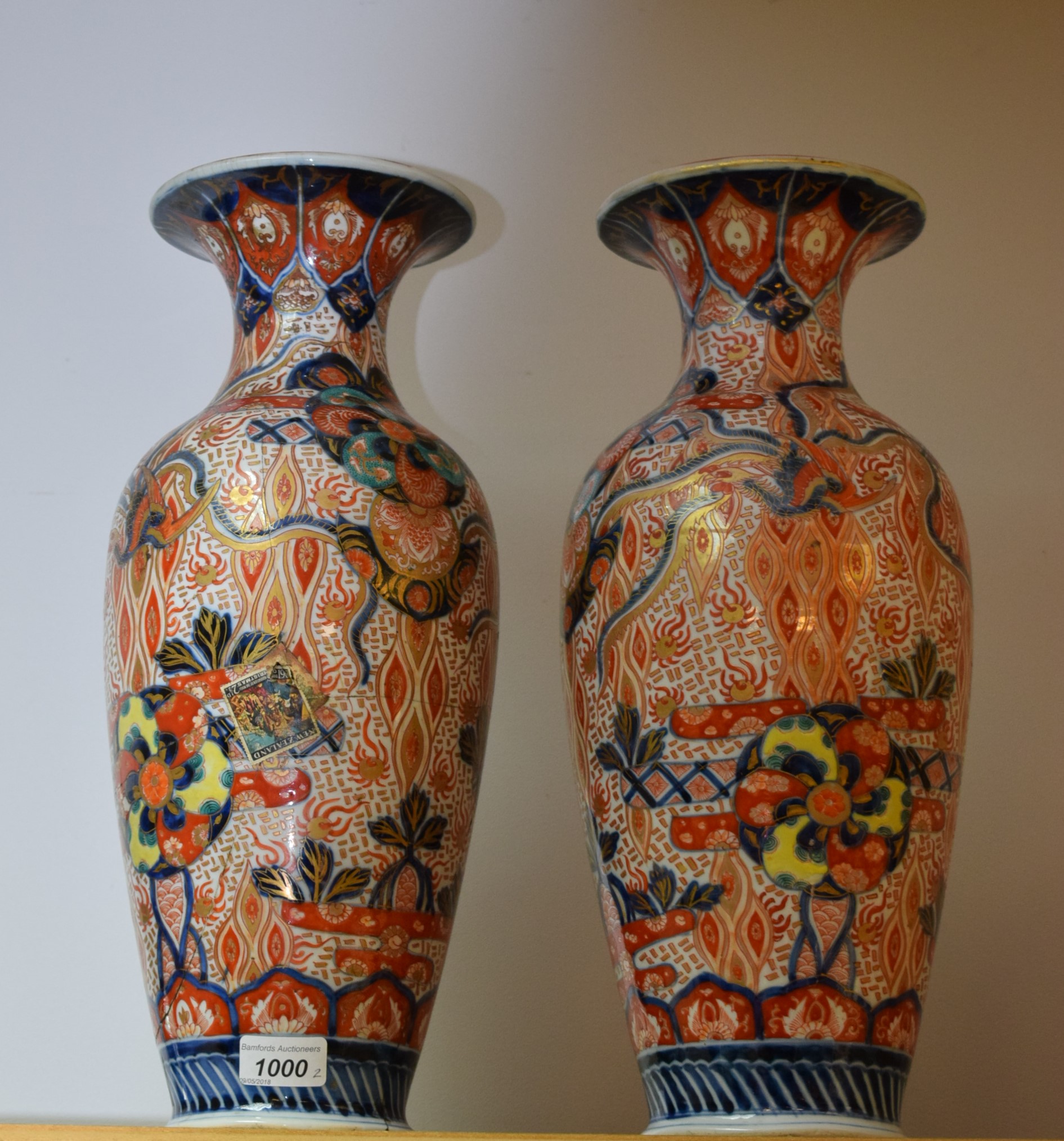 A pair of Japanese Imari baluster vases,decorated with mons and phoenix, 44cm high,