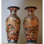 A pair of Japanese Imari baluster vases,decorated with mons and phoenix, 44cm high,