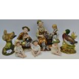 A Capodimonte style figural group of a Cobbler and his Grand daughter;