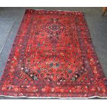 A Hamadan carpet in vibrant tones of Peacock blue, cerise and cream on a claret ground,