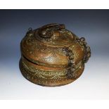 A Persian brass circular spice box, chased with lotus and bands of crescents,