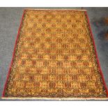 A Baluchi rug , in tones of burnt ochre and claret, geometric pattern,