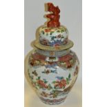 A Oriental temple jar and cover, decorated with stylised flowers and foliage, Lion finial,
