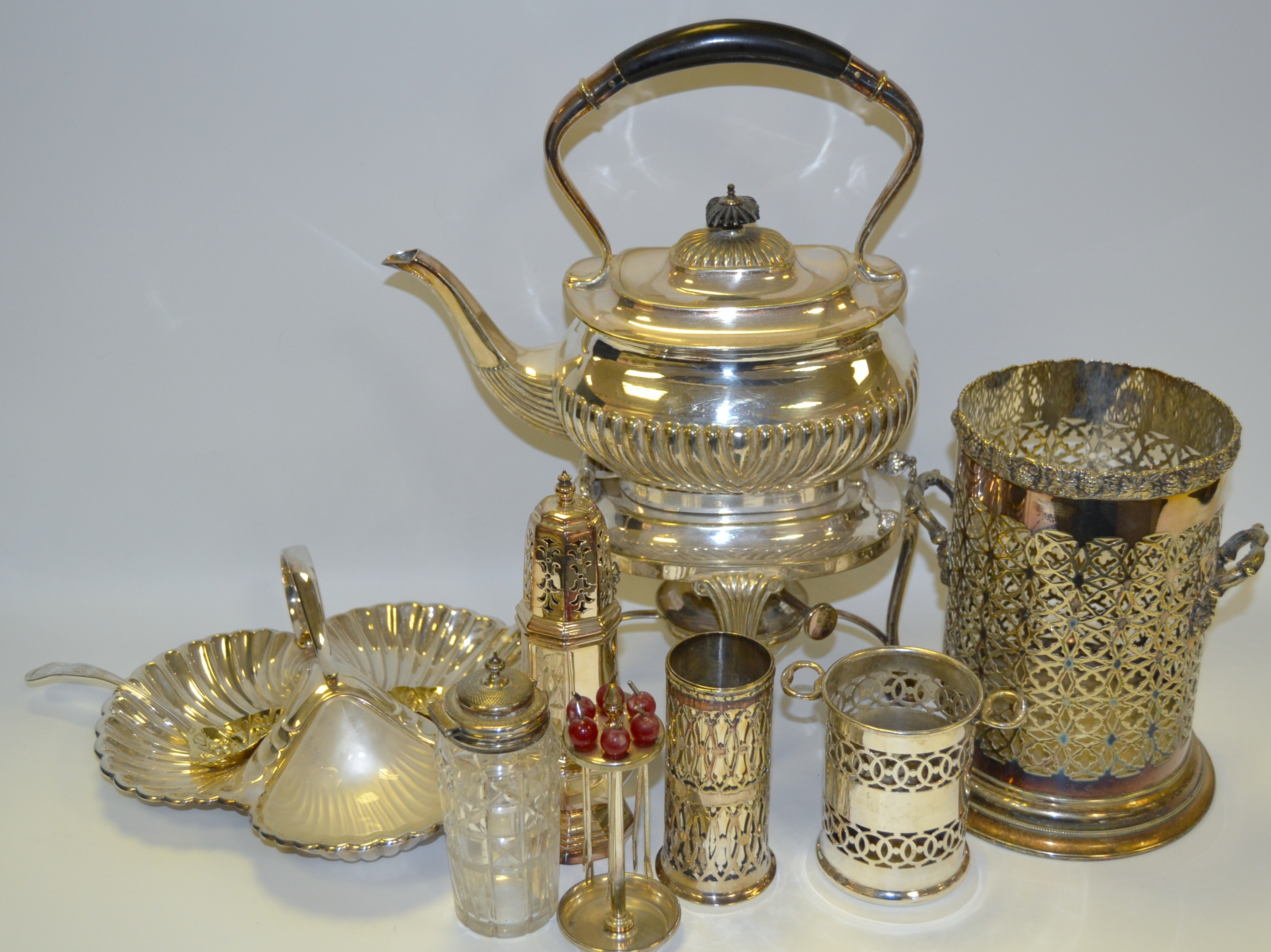 Silver Plated Ware - a silver plated spirit kettle; a bottle holder; sugar caster; trefoil dish;