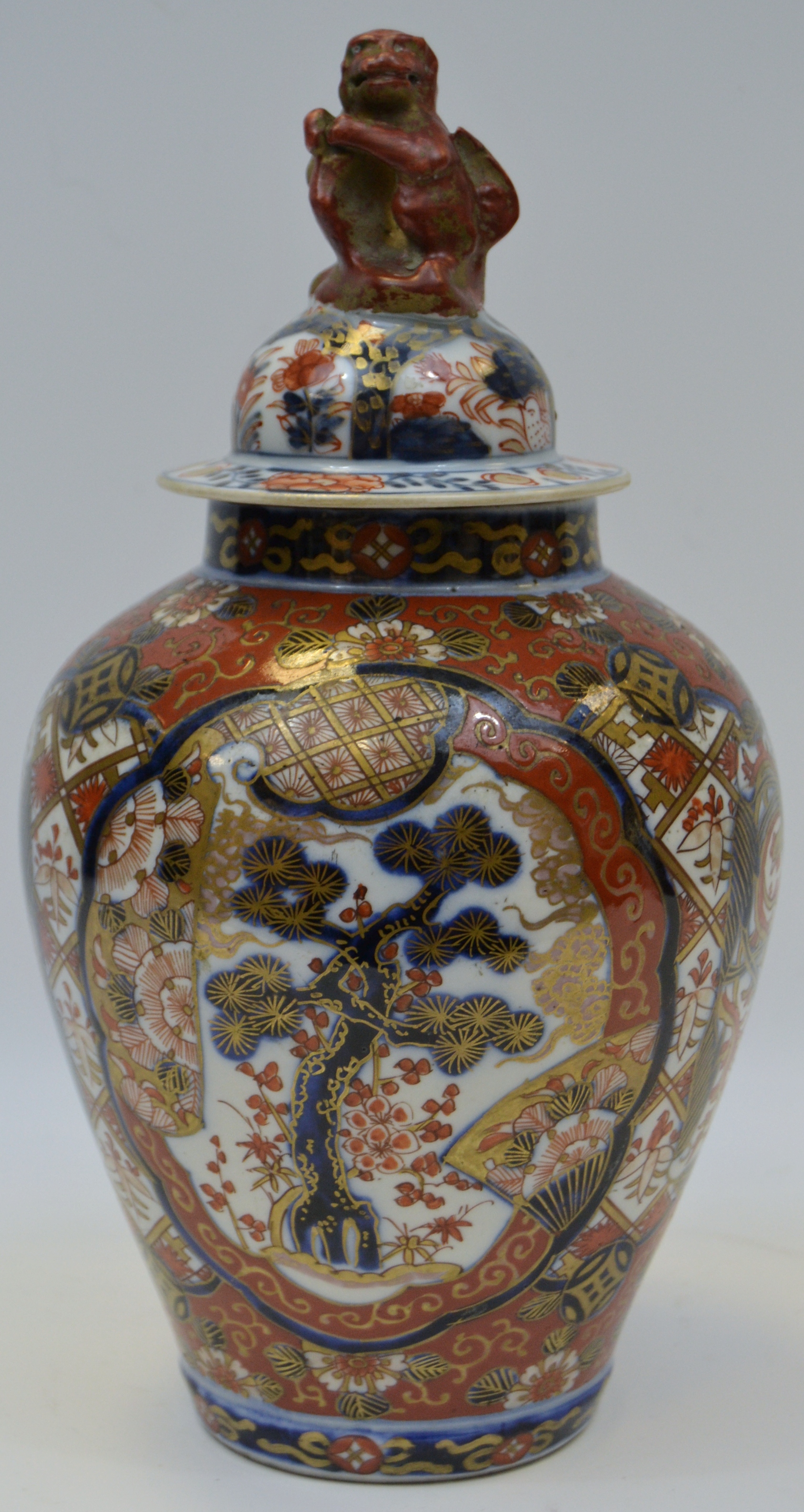 A Oriental temple jar and cover, decorated in the imari palate with stylised flowers and foliage,