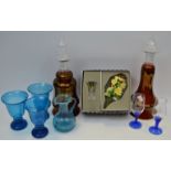 Glassware - a pair of ruby lustre glass decanters; a set of 3 blue glass goblets,