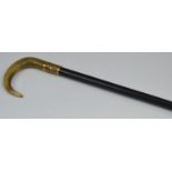 A Victorian walking stick, horn handle, gold plated collar embossed with scrolls, ebonised shaft,