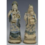 A pair of Chinese figures, of elders, both standing in robes, picked out in blue,