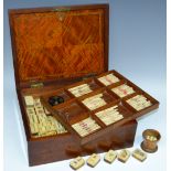 A late 19th century mahogany Mah-Jong set, bone and bamboo blocks and sticks,