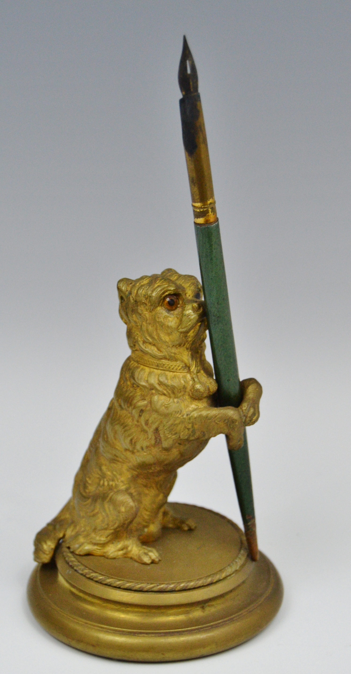 A 19th century gilt bronze novelty pen holder, as a terrier, on hind legs, glass eyes,