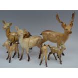 A Beswick Stag, model no. 981; a similar, Doe, model no. 998A; a Fawn, model no.