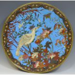 A Japanese circular cloisonne charger, inlaid with white bird and foliage, on a blue ground,
