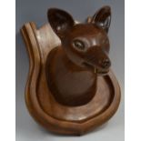 A hardwood carving, of a foxes head, shield shaped mount,