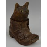 A 19th century novelty Black Forest inkwell, in the form of a cat in a boot, glass eyes, 12.