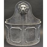 A substantial lead bow fronted water fountain, the arched back with lion mask, demi-lune trough,