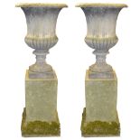 A large pair of Regency composition half-fluted two handled campagna garden urns,