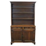 A 19th century oak side cabinet, the moulded cornice above three open shelves,