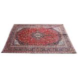 A Kashan carpet, central lozenge in tones of cream and indigo blue, conforming border,