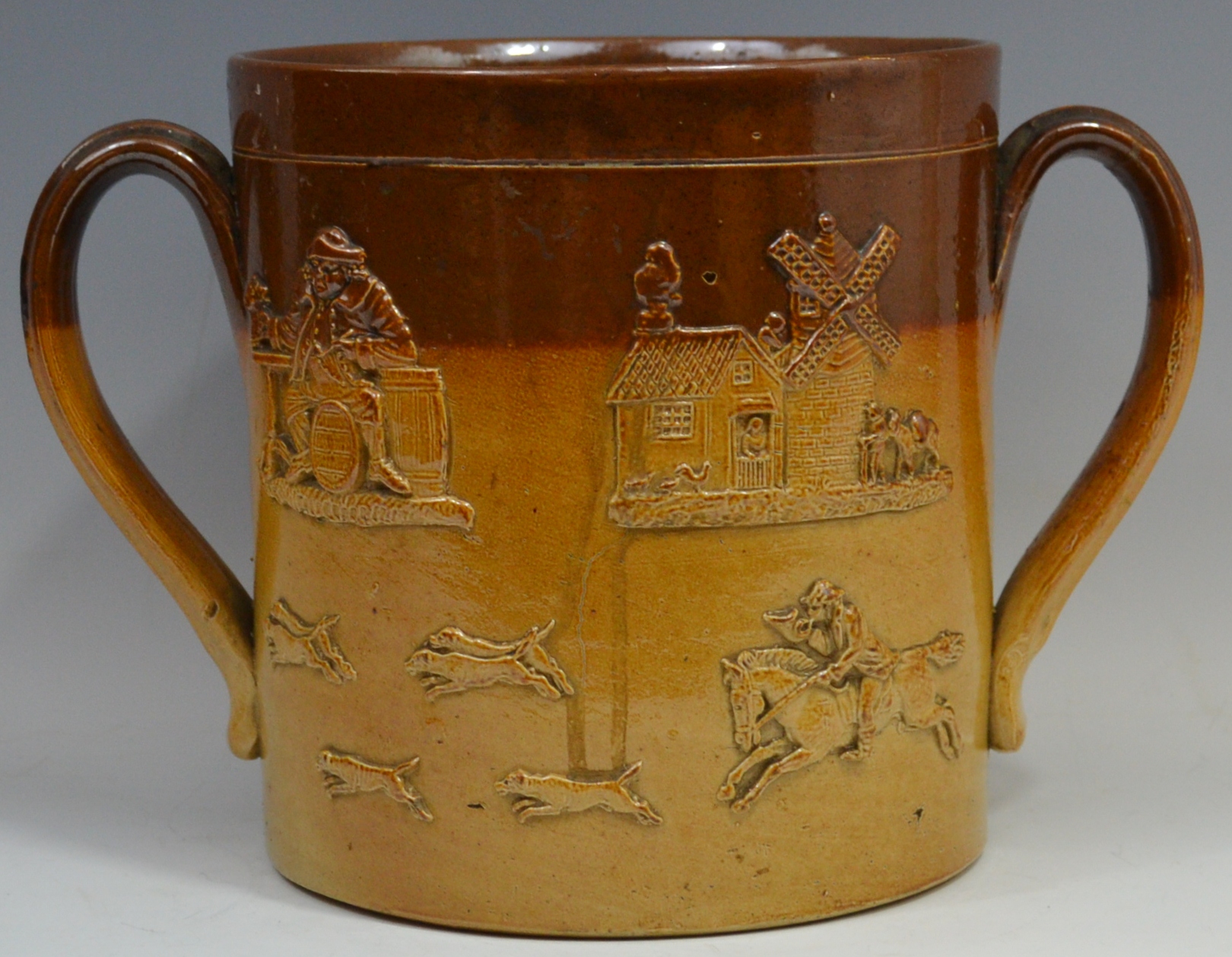 A 19th century brown salt glazed stoneware two handled loving cup,