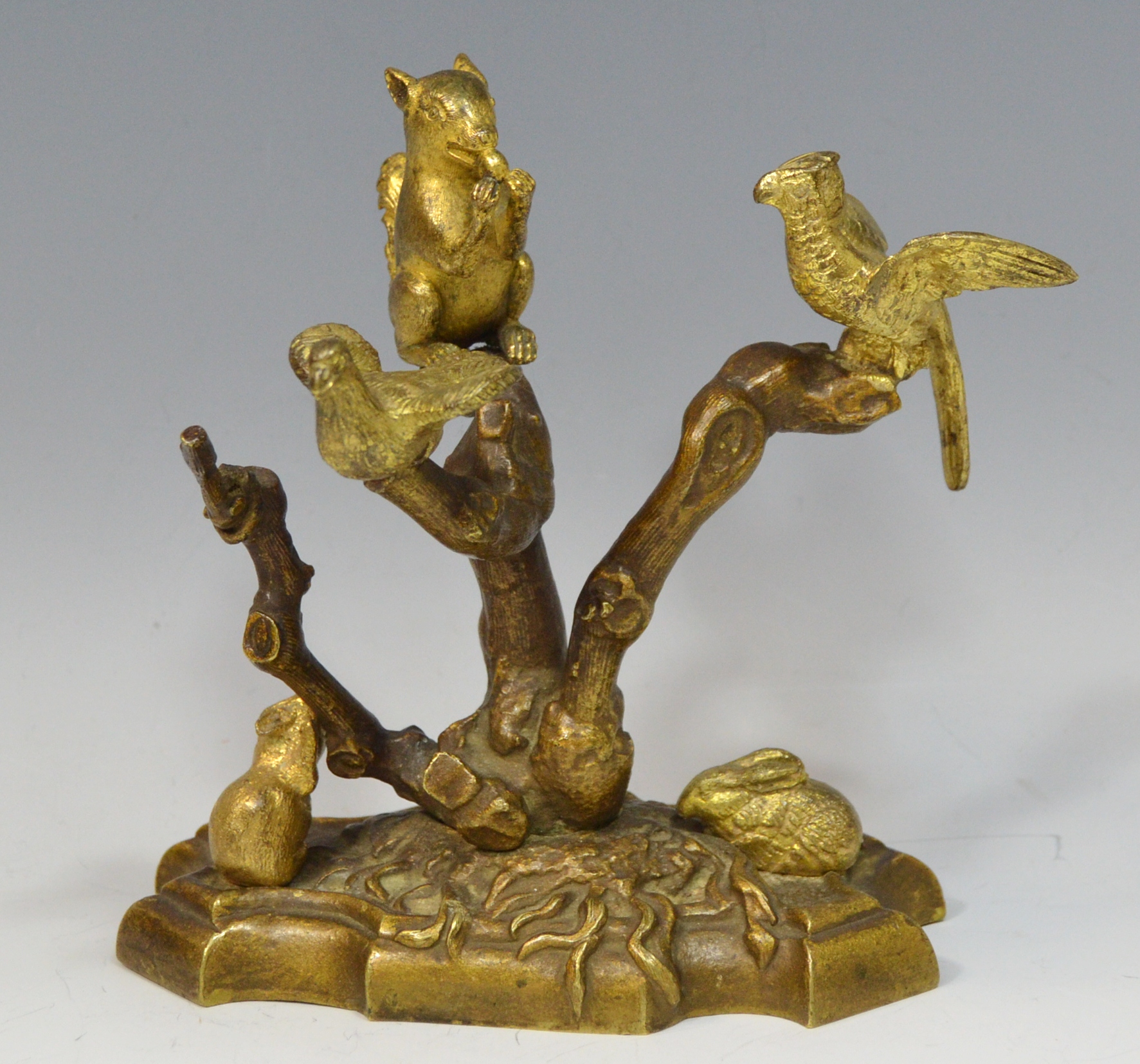 A 19th century gilt metal mantel model, of a squirrel and two birds perched in a tree,