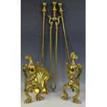 A pair of early 20th century brass andirons, in the form of stylised griffins,