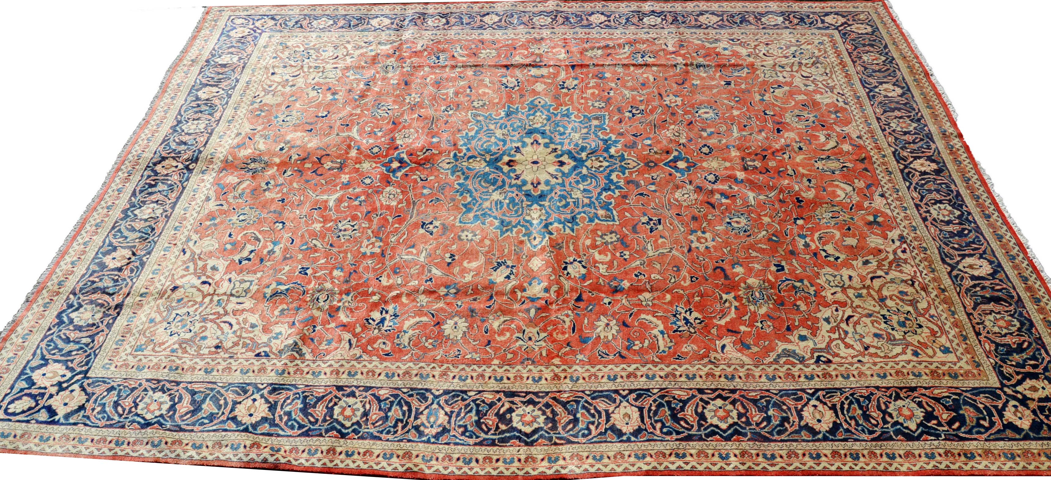 A Mahal carpet, the madder field in tones of cream , terracotta and blue, conforming border,