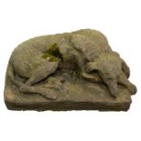 An 19th century gritstone model of an emaciated recumbent greyhound,