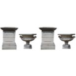 A pair of Regency design composition campana shaped garden urns, half fluted, square plinths,