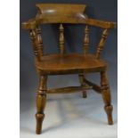 A child's elm smokers bow chair, turned spindles, shaped seat, turned legs, H stretcher,