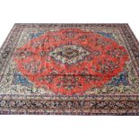 A Hamadan carpet, in tones of red and blue,