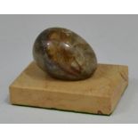 A Derbyshire feldspar egg, on rectangular marble plinth, 7.