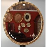 A circular wall mirror with gilt gesso frame,