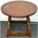 An Old Charm occasional table, circular top, spreading turned and blocked legs.