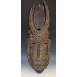 Tribal Art - an African mask, scarified features, lofty horns,
