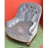 A Victorian walnut low armchair, curved buttoned back and scroll arms upholstered in blue velvet,