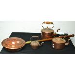 A Victorian copper kettle; another; a miniature copper kettle;