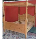 A 19th century style pine four poster bed,