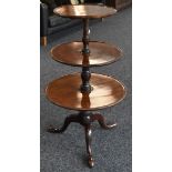 A George III mahogany three-tier dumbwaiter, graduated dished circular plateaux, turned pillar,