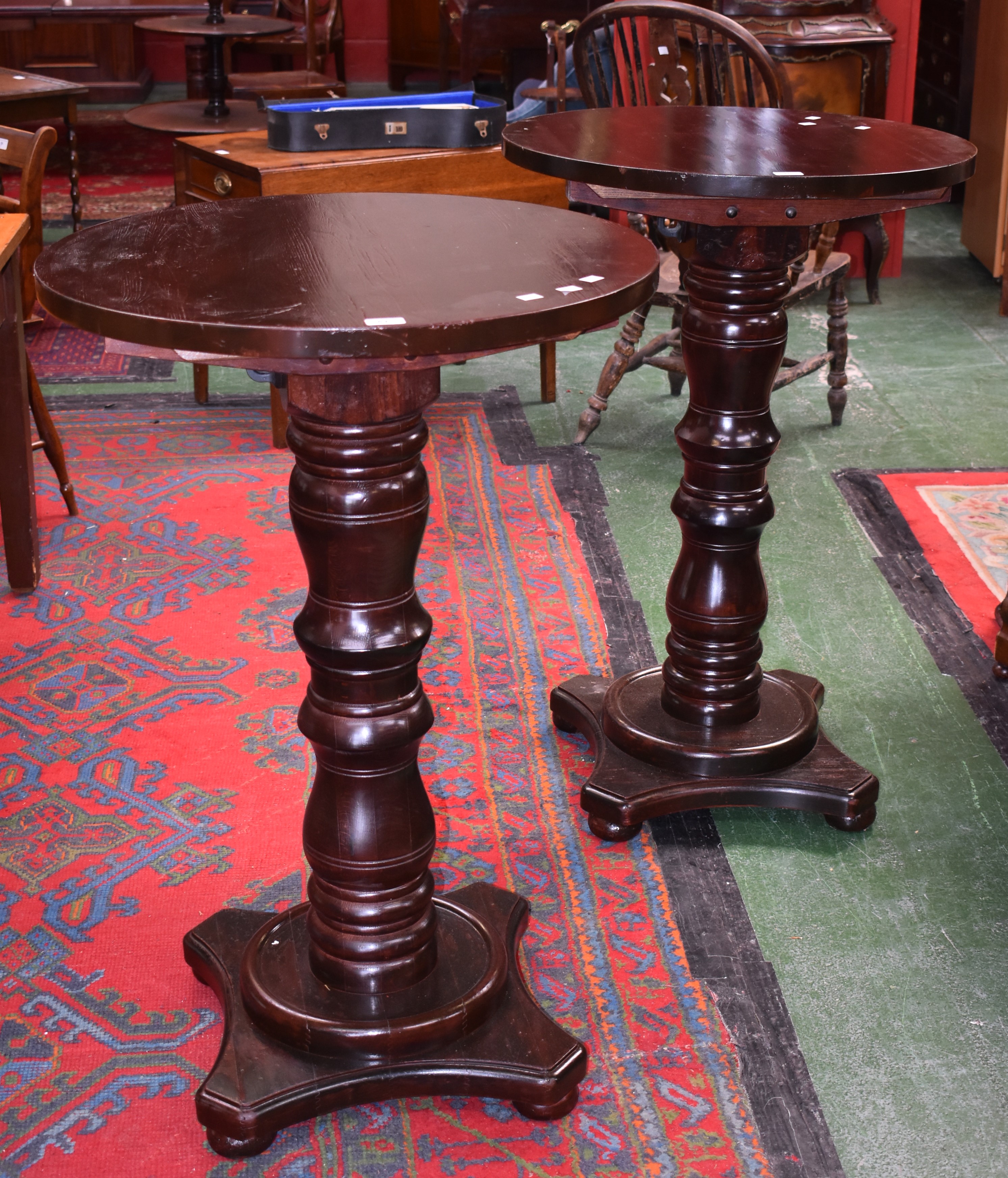 A pair of bar high tables, circular top, turned column, quatrefoil base, bun feet, 105cm high,