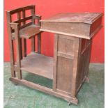 An oak clerk's desk, hinged slope, panelled door cupboard to front, attached seat, ceramic casters.