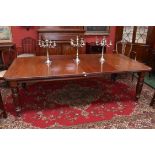 A Victorian Mahogany wind-out dining table, having a rectangular top with canted corners,