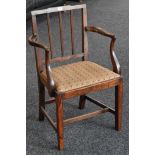 A George III elm elbow chair, reeded splat, drop in seat,